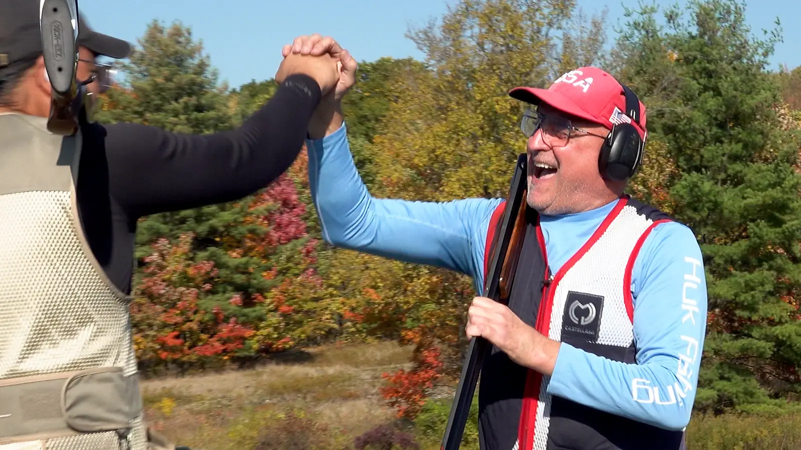Two shooters celebrating with a high five